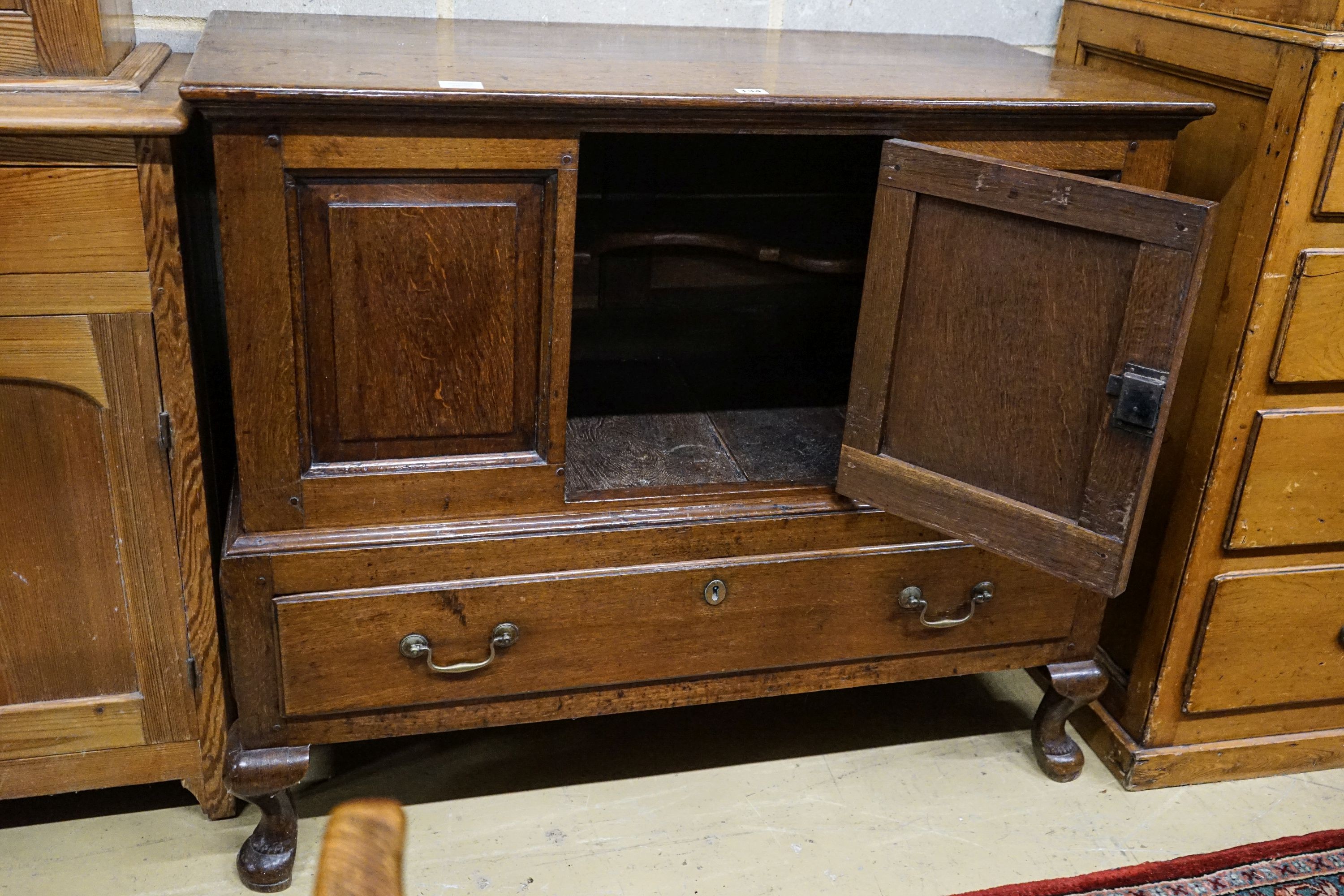 A mid 18th century oak mule chest, with later converted central door and later stand with cabriole legs, width 109cm, depth 53cm, height 93cm